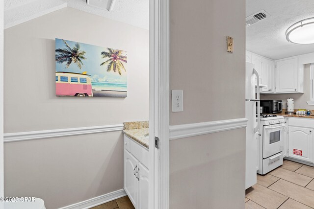 washroom with light tile patterned floors, a healthy amount of sunlight, washer / dryer, and laundry area