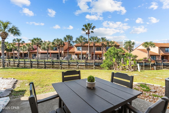 view of patio with a water view, a residential view, and outdoor dining area