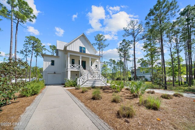 205 Mallard Ln, Santa Rosa Beach, FL 32459 - view of front of home with driveway, a porch, a garage, stairs, and board and batten siding