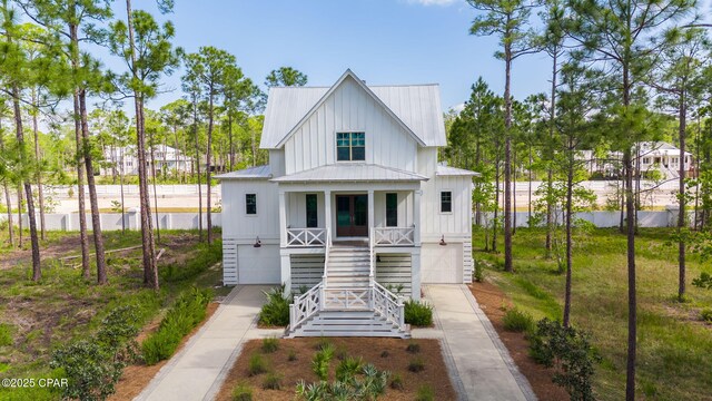 205 Mallard Ln, Santa Rosa Beach, FL 32459 - back of house with driveway, a porch, metal roof, an attached garage, and stairway