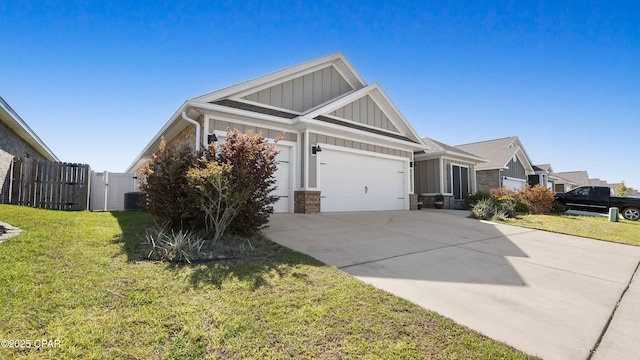4744 Rosemary St, Panama City, FL 32404 - view of front facade featuring board and batten siding, concrete driveway, a front lawn, and a garage