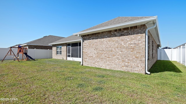 4744 Rosemary St, Panama City, FL 32404 - rear view of property with a lawn, brick siding, and a fenced backyard