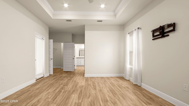4744 Rosemary St, Panama City, FL 32404 - unfurnished bedroom with light wood-style floors, a raised ceiling, baseboards, ornamental molding, and visible vents