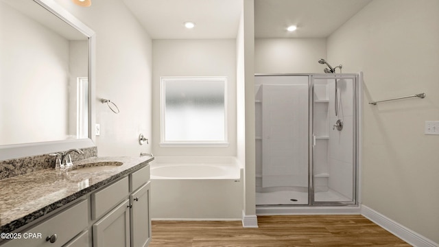 4744 Rosemary St, Panama City, FL 32404 - bathroom featuring a shower stall, a garden tub, vanity, and wood finished floors