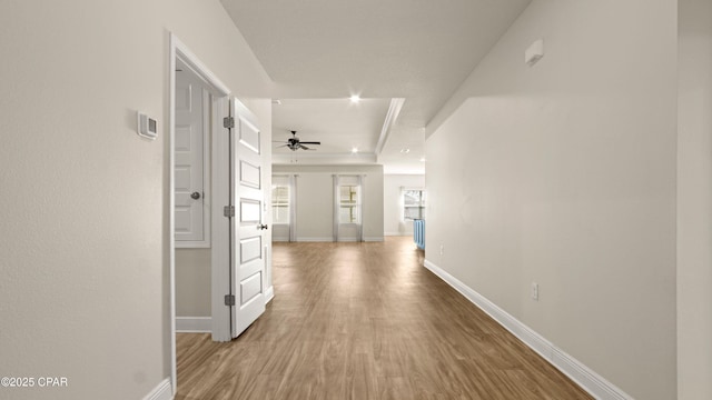 4744 Rosemary St, Panama City, FL 32404 - hall featuring a tray ceiling, wood finished floors, and baseboards
