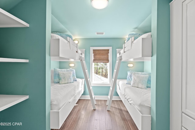 mudroom with visible vents, baseboards, and wood finished floors