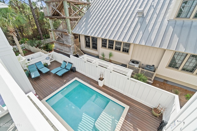 outdoor pool featuring a deck and fence