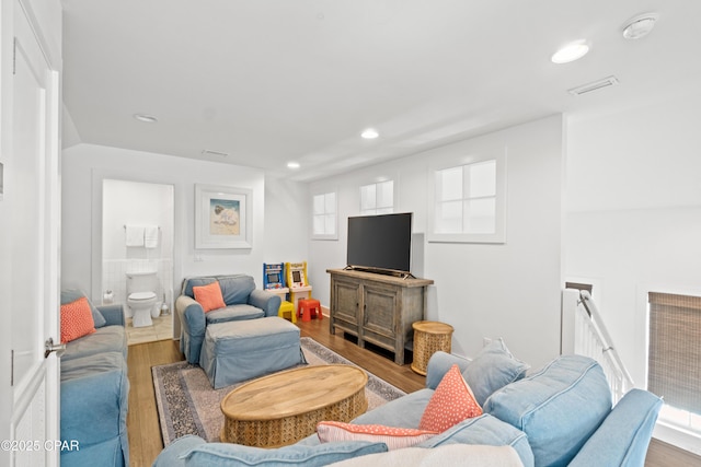 living room with recessed lighting and wood finished floors