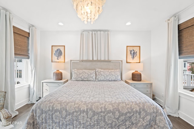 bedroom featuring dark wood-style flooring, baseboards, a notable chandelier, and recessed lighting
