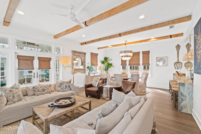 living room featuring baseboards, ceiling fan with notable chandelier, recessed lighting, and visible vents