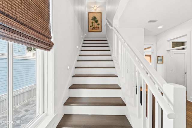stairs featuring visible vents, recessed lighting, and wood finished floors