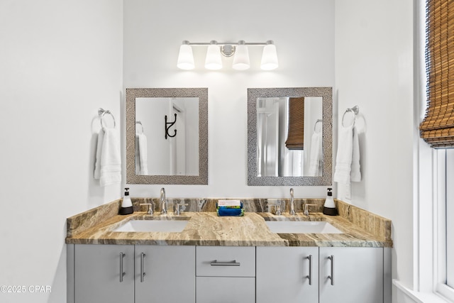 full bath with a sink and double vanity