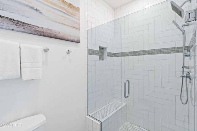 bathroom with toilet and a shower stall