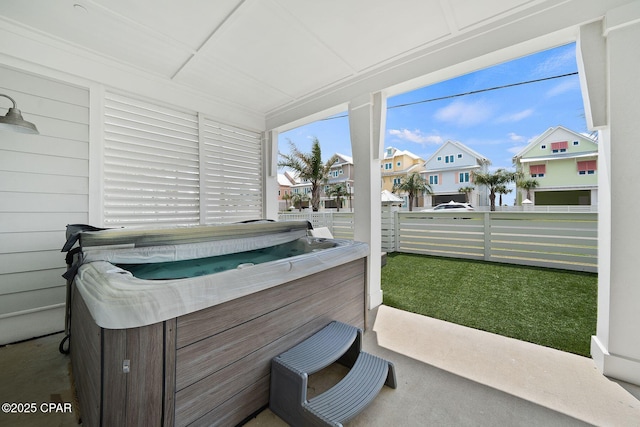 sunroom / solarium with a jacuzzi and a residential view