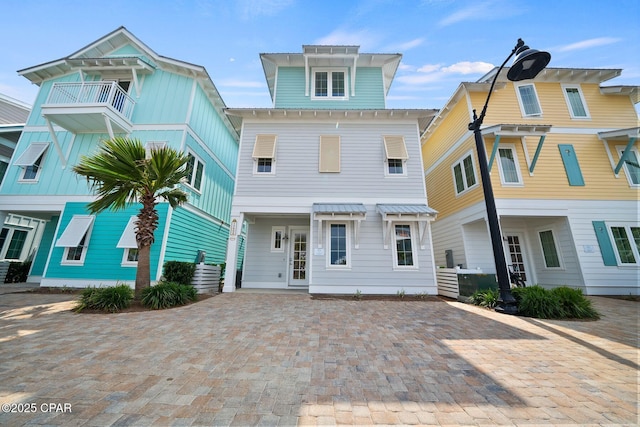 view of front of home with decorative driveway and metal roof