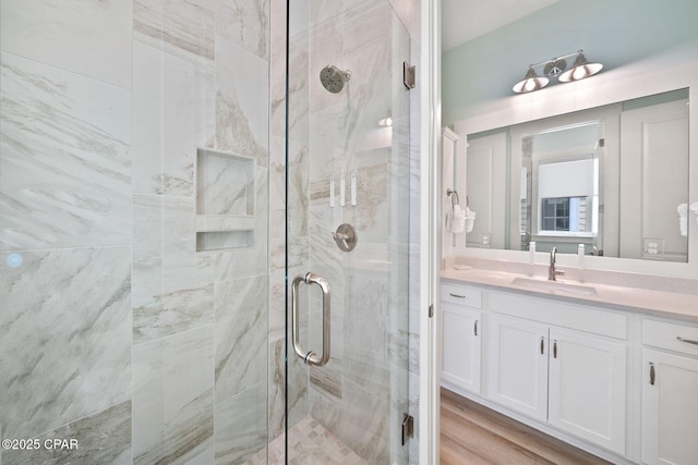 full bath with a shower stall and vanity
