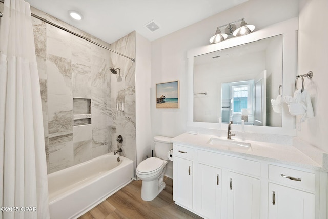 full bathroom with shower / bathtub combination with curtain, wood finished floors, visible vents, toilet, and vanity