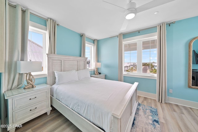 bedroom with light wood-style floors and baseboards