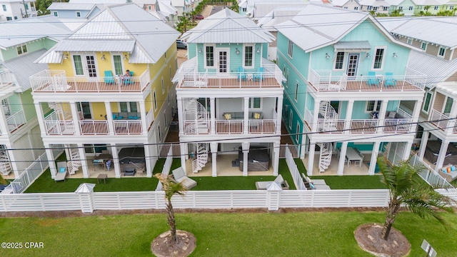 back of property with a patio area, a residential view, a fenced backyard, and a lawn