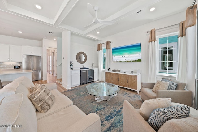 living room with visible vents, wood finished floors, beverage cooler, and recessed lighting