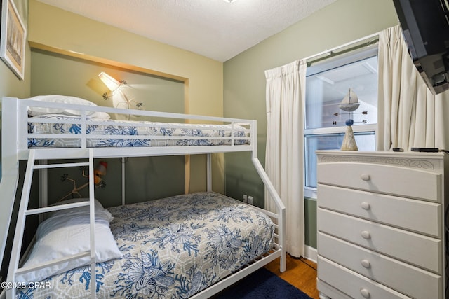 14825 Front Beach Rd Unit 2205, Panama City Beach, FL 32413 - bedroom featuring a textured ceiling and wood finished floors