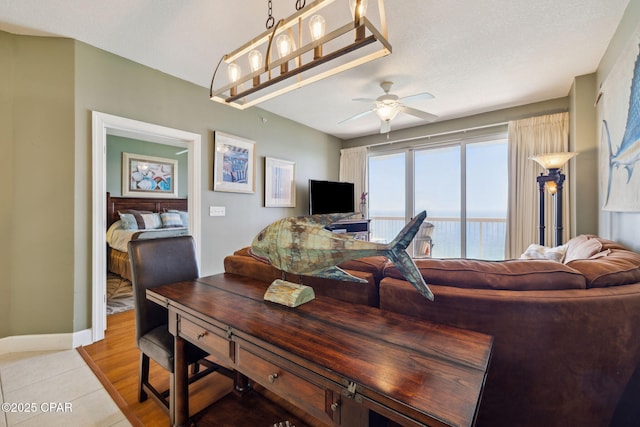 14825 Front Beach Rd Unit 2205, Panama City Beach, FL 32413 - living room featuring light tile patterned flooring, baseboards, and a ceiling fan