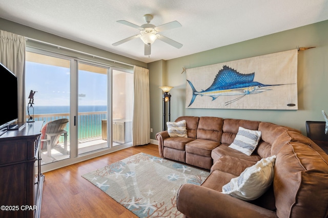 14825 Front Beach Rd Unit 2205, Panama City Beach, FL 32413 - living area with a water view, a ceiling fan, and wood finished floors
