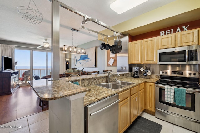 14825 Front Beach Rd Unit 2205, Panama City Beach, FL 32413 - kitchen featuring a sink, stainless steel appliances, open floor plan, a ceiling fan, and light brown cabinets