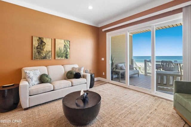 living area with wood finished floors, recessed lighting, and a water view