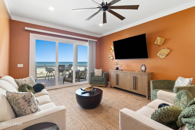 living area with recessed lighting, light wood finished floors, and a ceiling fan