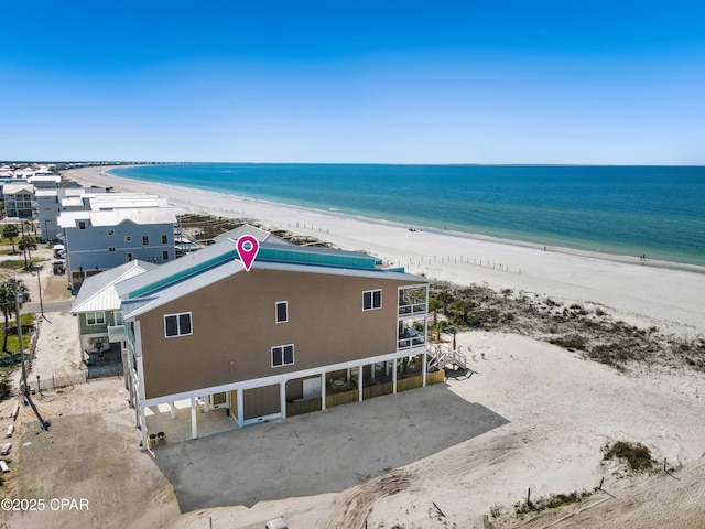 bird's eye view featuring a view of the beach and a water view