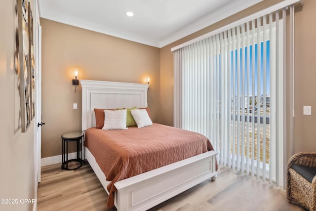 bedroom featuring recessed lighting, wood finished floors, baseboards, and access to outside