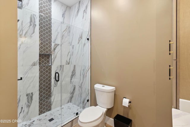 full bathroom featuring a marble finish shower and toilet