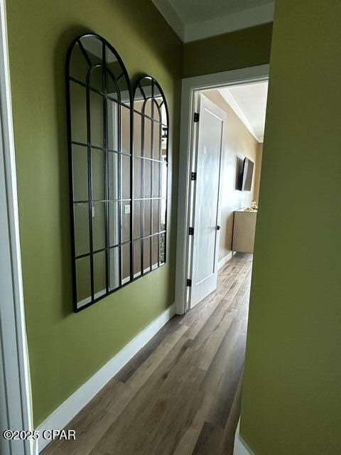 hallway with wood finished floors and baseboards