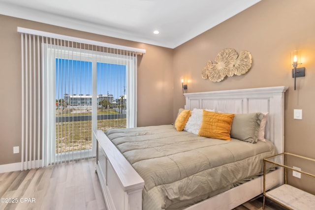 bedroom featuring baseboards, wood finished floors, and recessed lighting