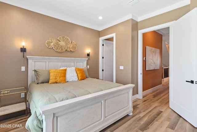 bedroom with recessed lighting, light wood-style flooring, visible vents, and baseboards