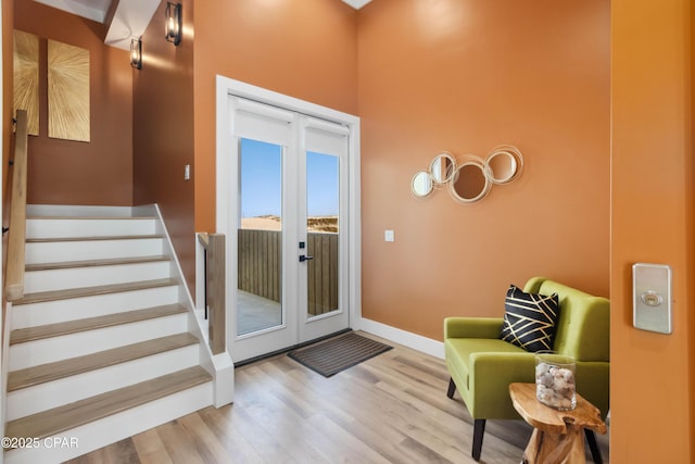 doorway to outside featuring stairs, wood finished floors, and baseboards