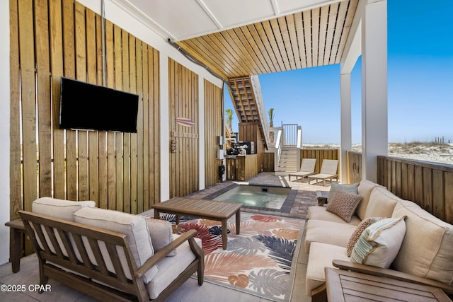 exterior space with an outdoor hot tub and an outdoor living space