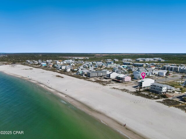 drone / aerial view featuring a view of the beach and a water view