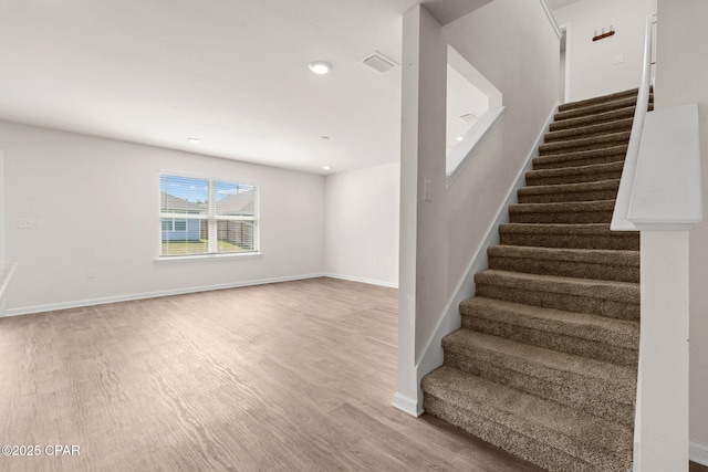 stairs featuring baseboards, recessed lighting, wood finished floors, and visible vents