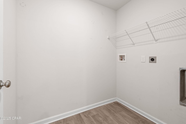 washroom featuring hookup for an electric dryer, laundry area, wood finished floors, baseboards, and hookup for a washing machine