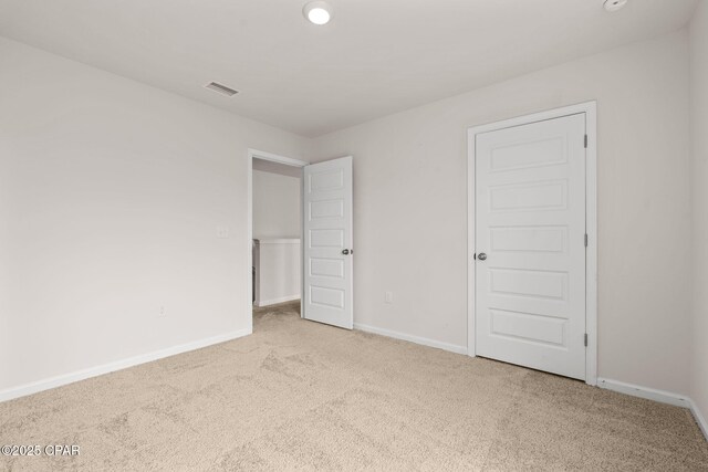 unfurnished bedroom featuring recessed lighting, baseboards, visible vents, and carpet