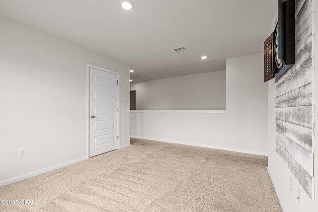 carpeted spare room with recessed lighting, baseboards, and visible vents