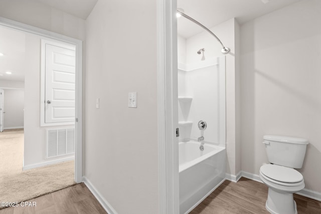 bathroom with visible vents, baseboards, wood finished floors, and toilet