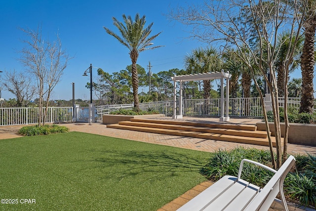 view of home's community with a yard and fence
