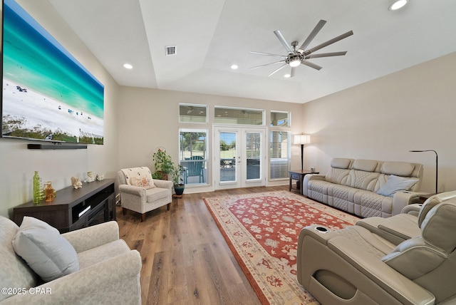 living area with wood finished floors, ceiling fan, recessed lighting, and visible vents