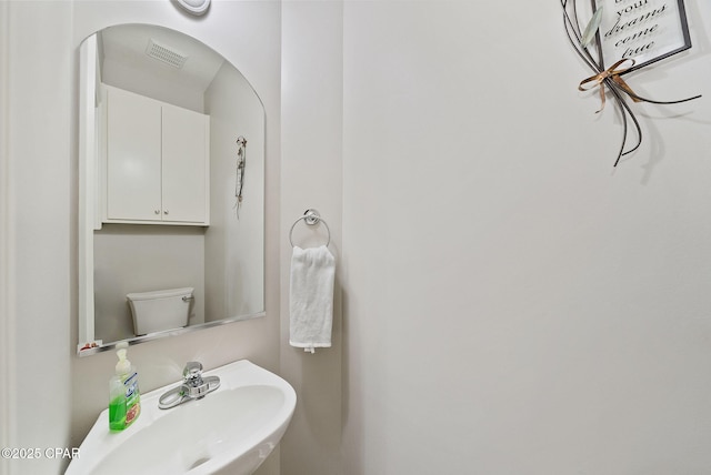 bathroom featuring visible vents and a sink