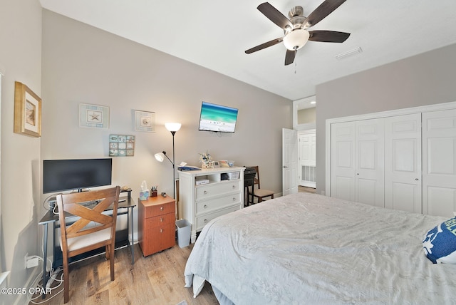 bedroom featuring visible vents, ceiling fan, a closet, and light wood finished floors