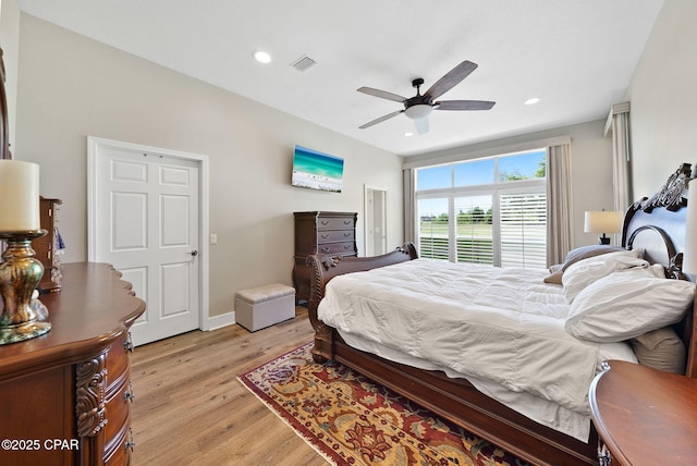 bedroom featuring light wood-style flooring, visible vents, baseboards, recessed lighting, and a ceiling fan