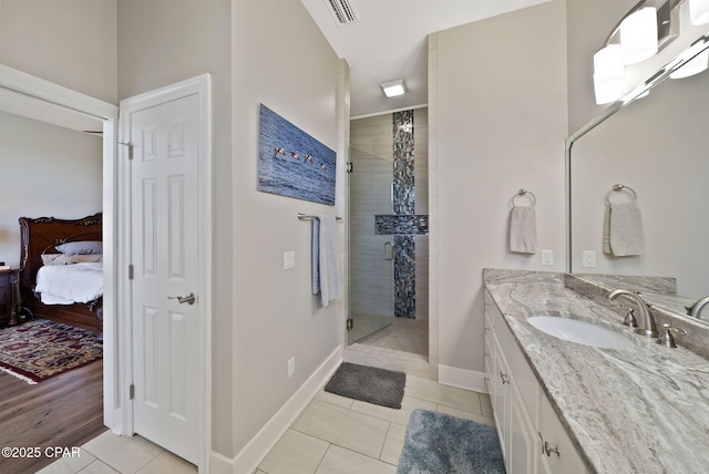 ensuite bathroom with connected bathroom, tile patterned flooring, a shower stall, vanity, and visible vents